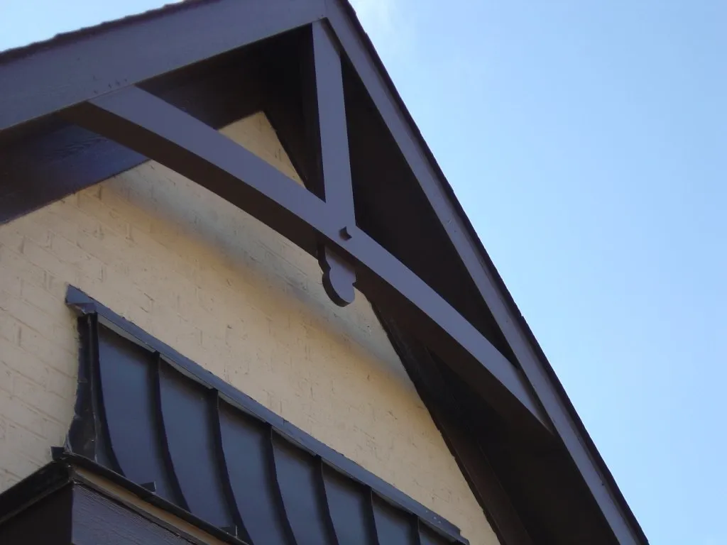 Remodel: an arched cedar bracket added to a home's gable.
